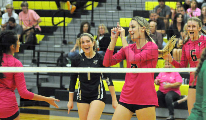 Bishop Moore players (from left) Sophia Iglesias, Lauren Vintilla, Jaide Wirth and Anika Groom celebrate one of Wirth's six kills against Lake Placid in Thursday's Region 2-4A quarterfinal match.